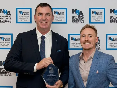 Two of the Guardian Screens & Shutters team with the NSSA trophy reading 2024 National Winner, Best Installation Commercial