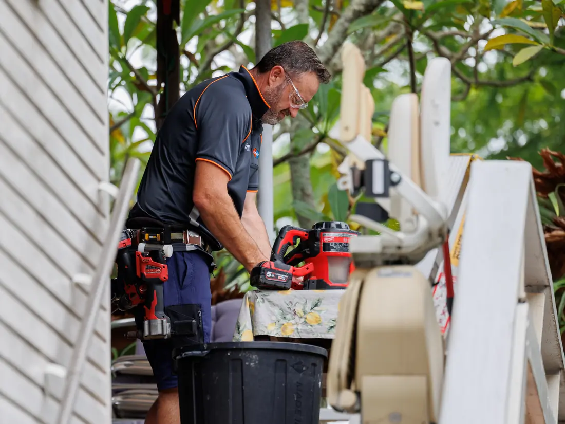 Simon, a Guardian Screens & Shutters installer in his Guardian work shirt, at work on a customer's home